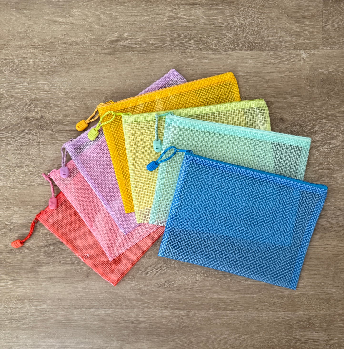 Assortment of colorful mesh zippered Water Watch pouches in coral, pink, lavender, yellow, green, mint, and blue. Colors vary based on availability and cannot be selected at this time.